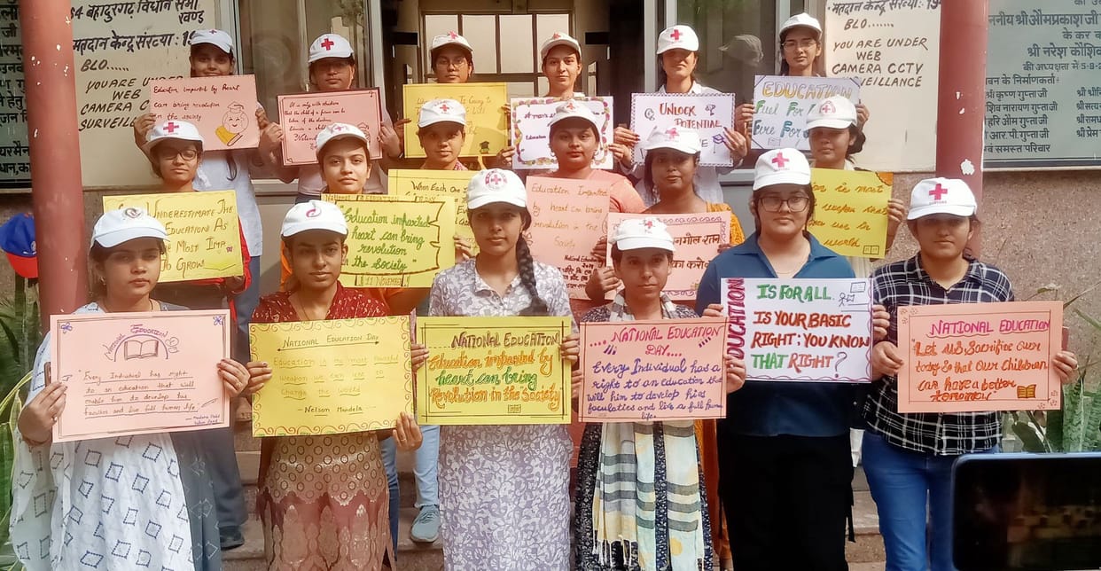 Volunteers celebrated National Education Day by writing slogans