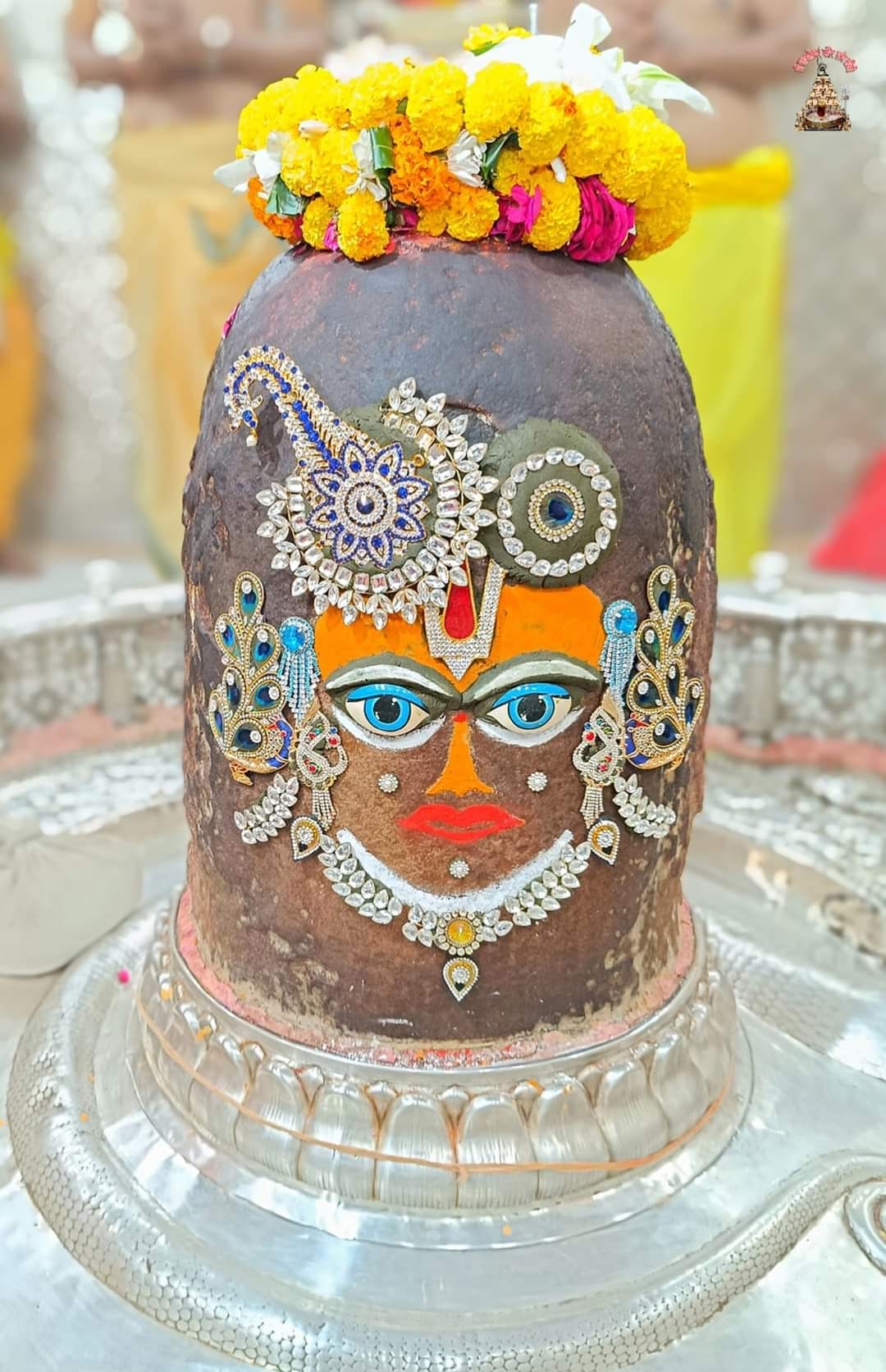 Devuthani Ekadashi, Baba Mahakal dressed in form of Shri Krishna wearing a garland of oranges and flowers