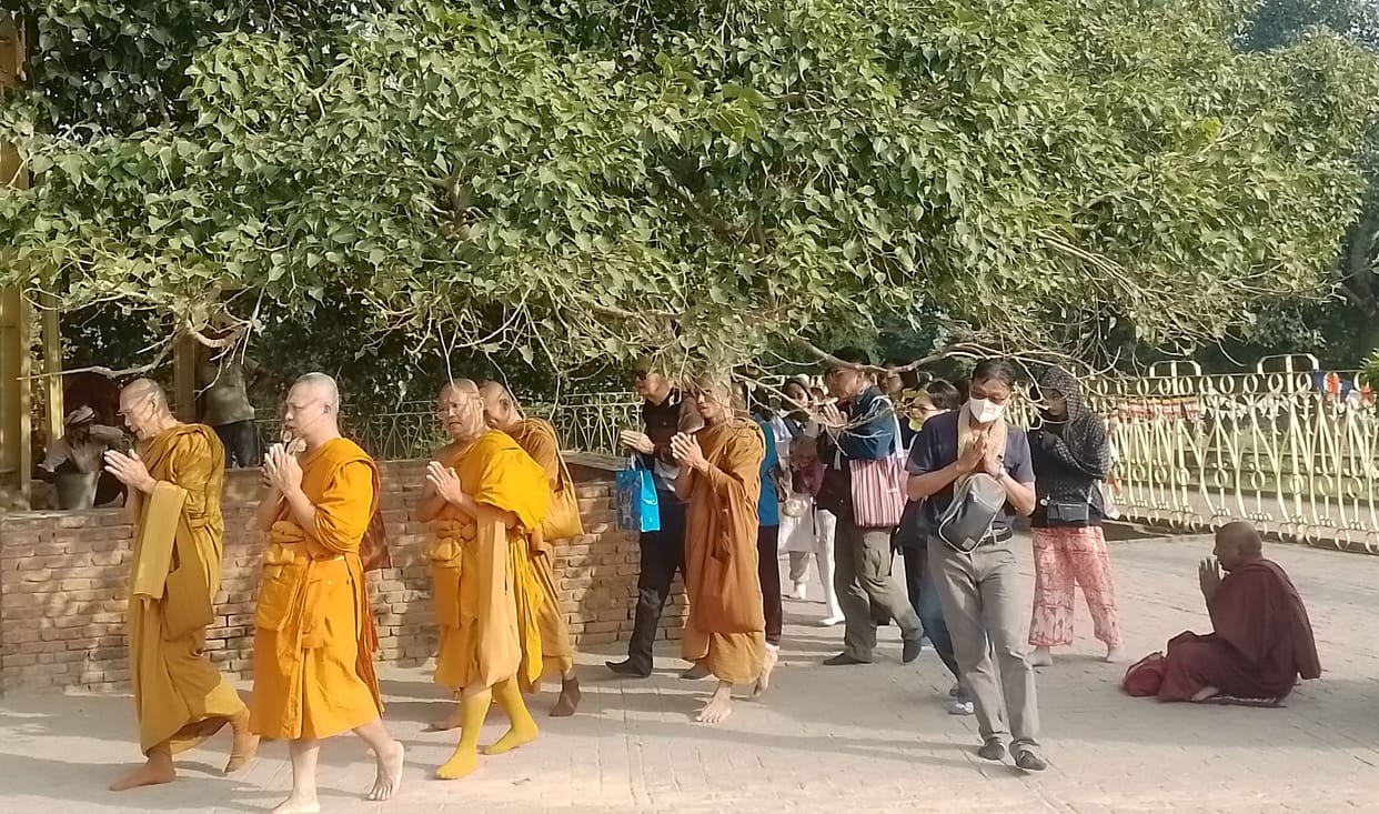Followers prayed after circumambulating Anand Bodhi