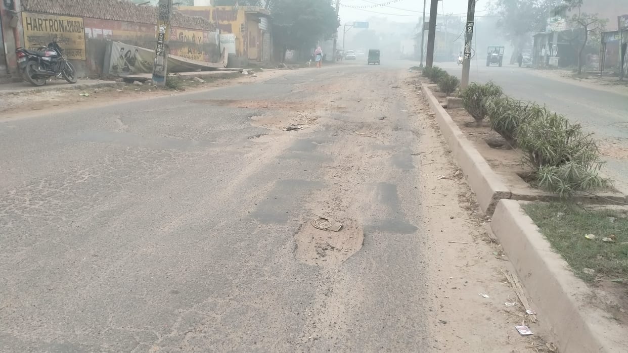 There are potholes and the road is rough at some places.