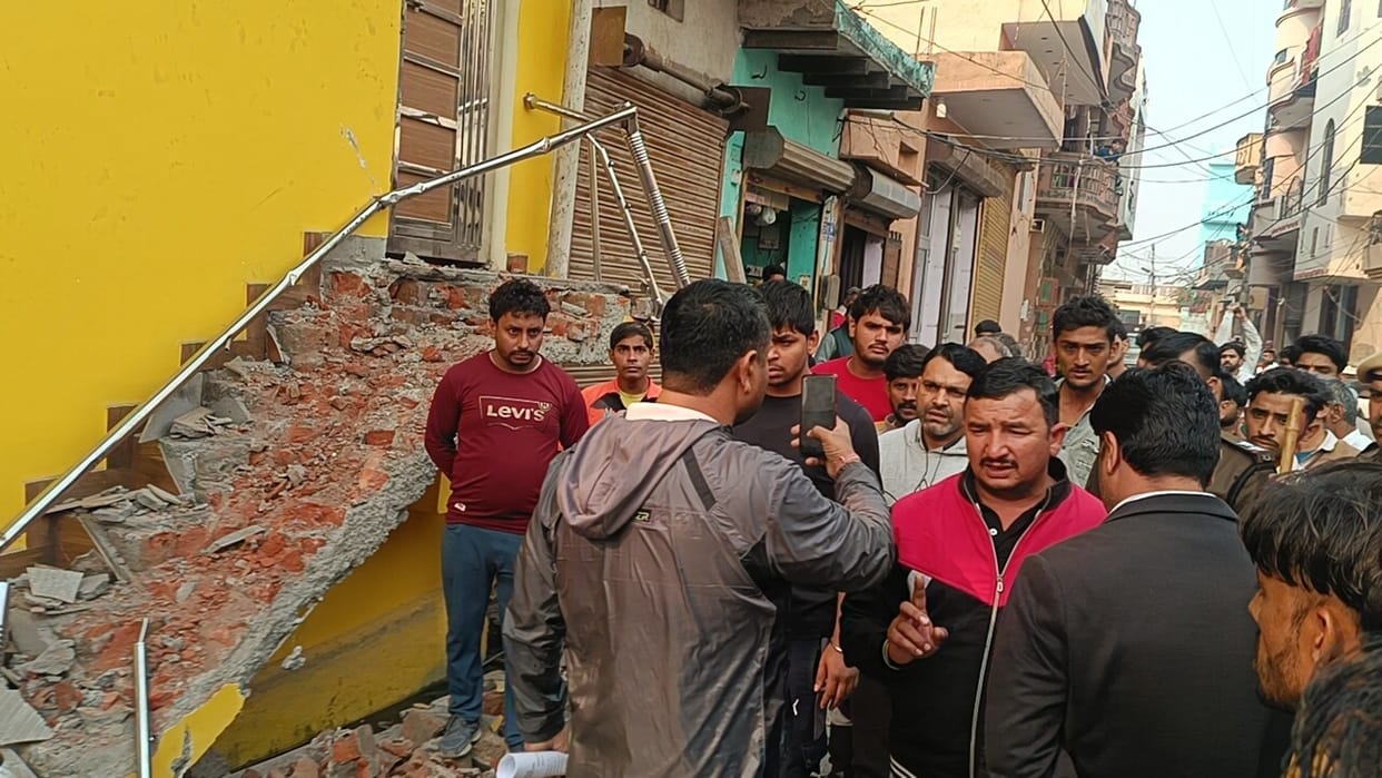 Old iron gate removed from the street, staircase constructed, bulldozer started