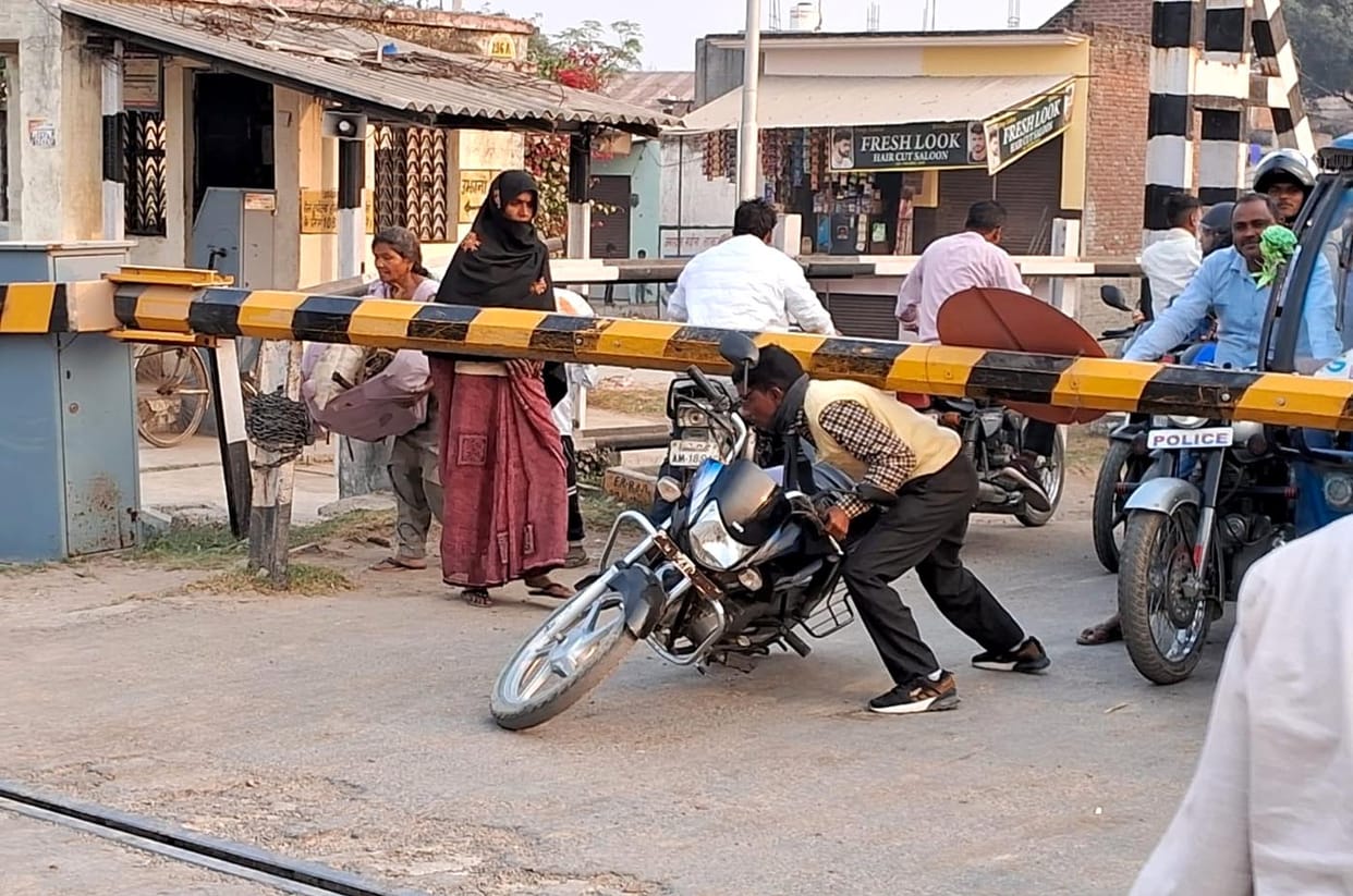 Life at risk... The gate is closed but still the bike riders do not listen