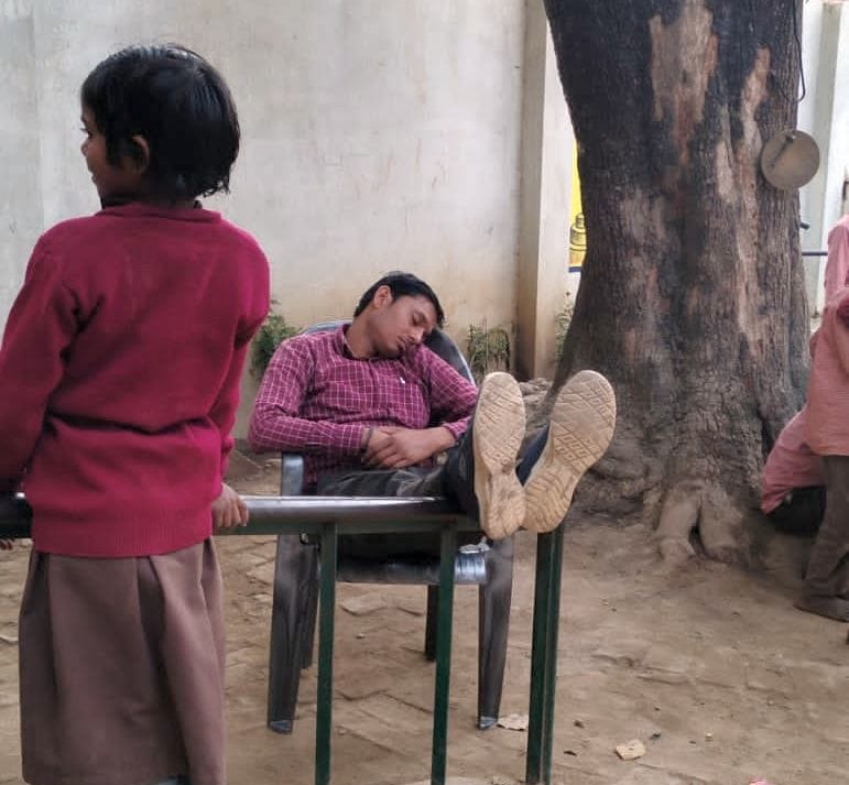 Photo of teacher sleeping with his feet on the table in school goes viral