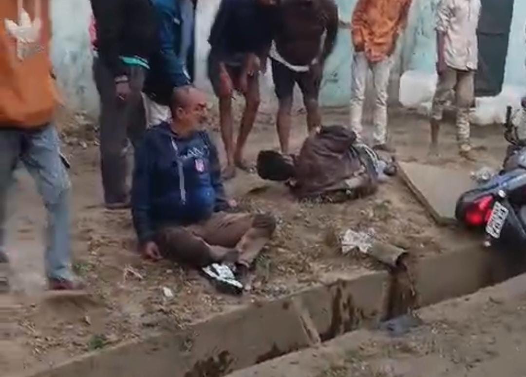 The speeding car came on the wrong side, the bike rider went out of control and entered the drain.