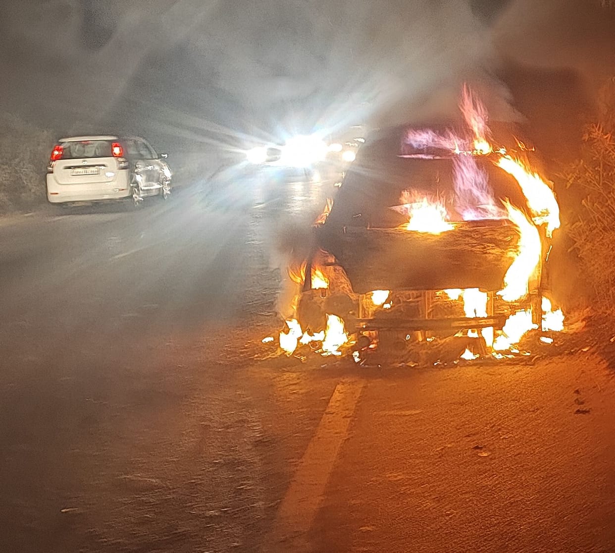 Car catches fire on highway, passengers survive