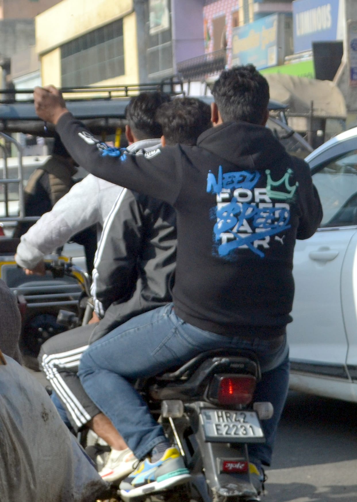 Without helmet on two-wheeler...three riding along