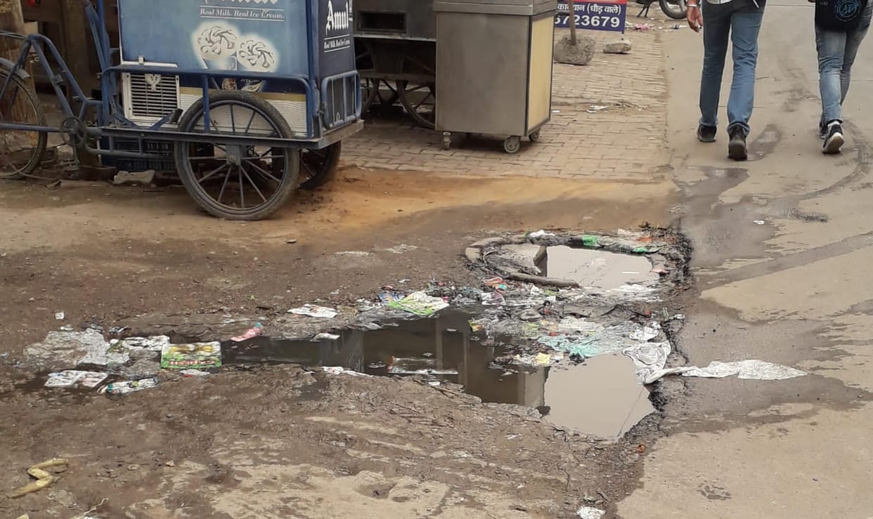 Water is coming out from the manhole of the model, people