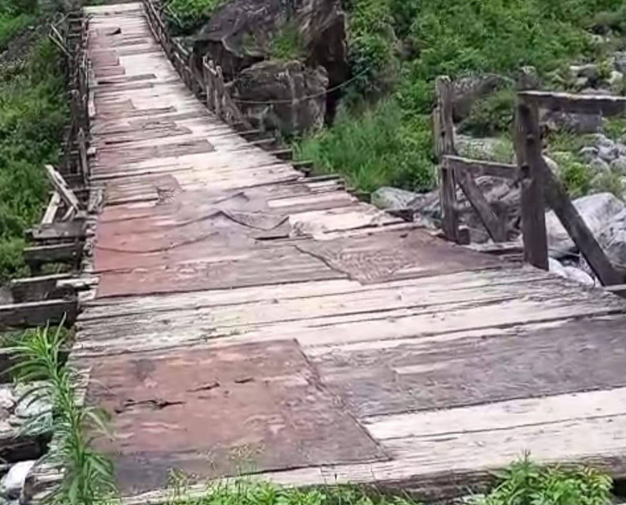 Wooden bridge ready to collapse, crossing at risk of life