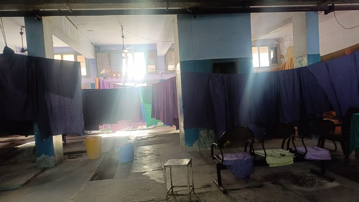 The bedsheet press machine in the laundry of civil hospital broke down, the bedsheets were drying with the fan.