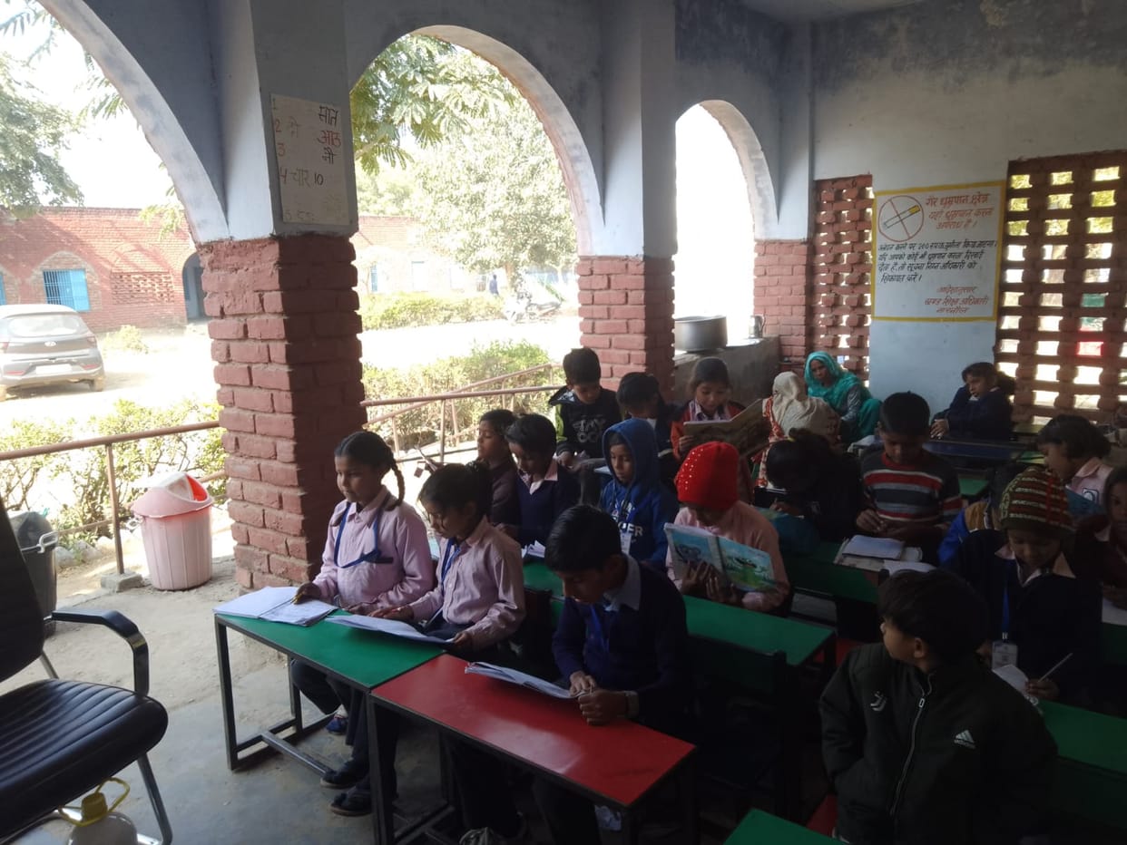 Children forced to study in the open verandah, busy in responsible paperwork