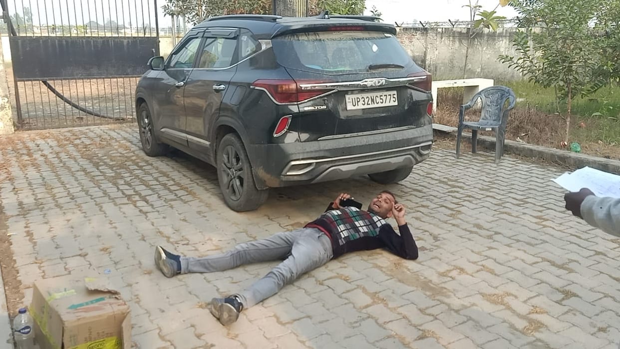 A young man lay down under the SDO's car with a bottle of petrol