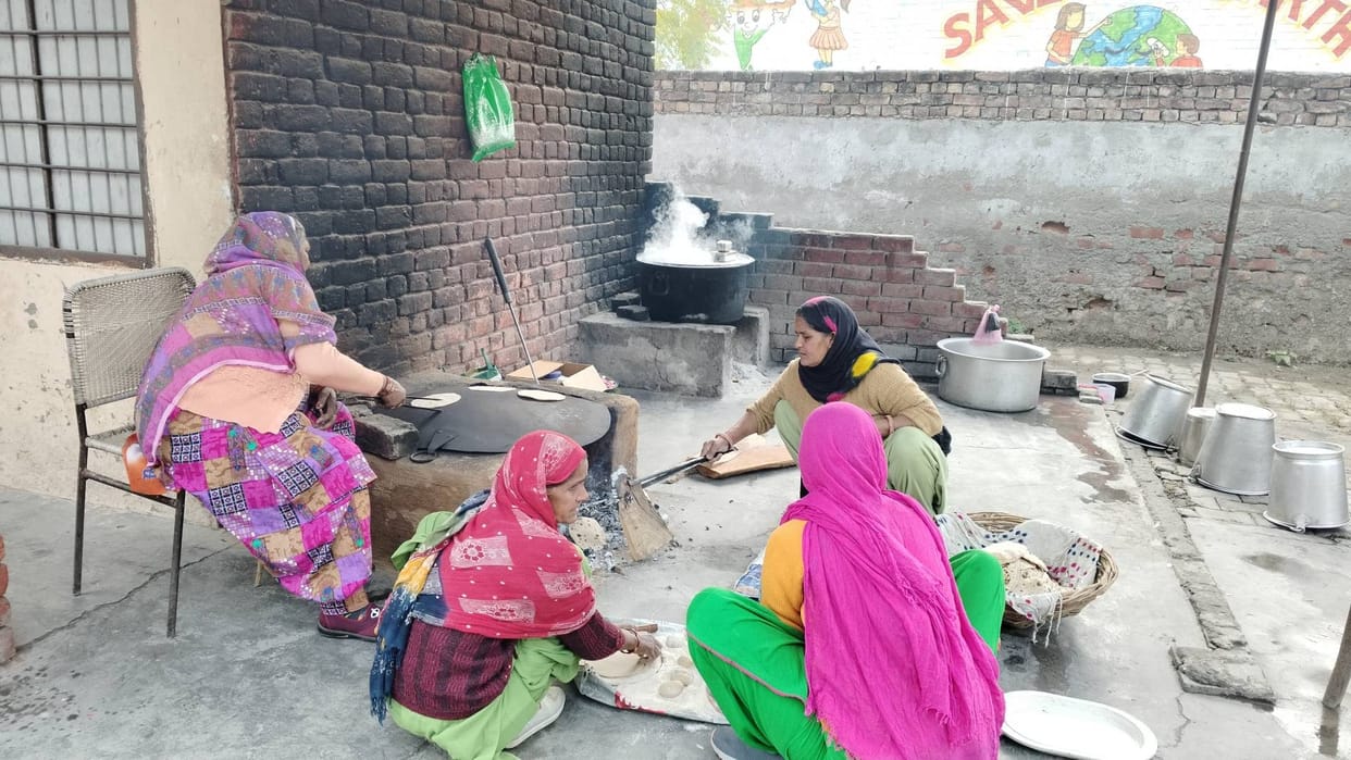 There is a gas cylinder but no furnace, mid day meal is being prepared on wood