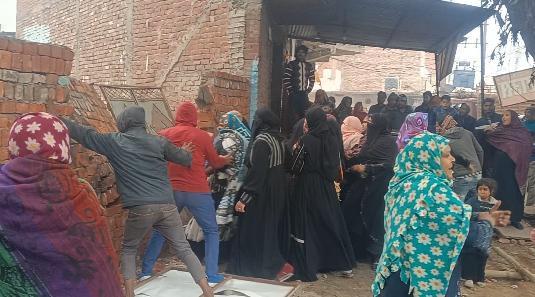 Angry women demolished the wall built on the disputed land