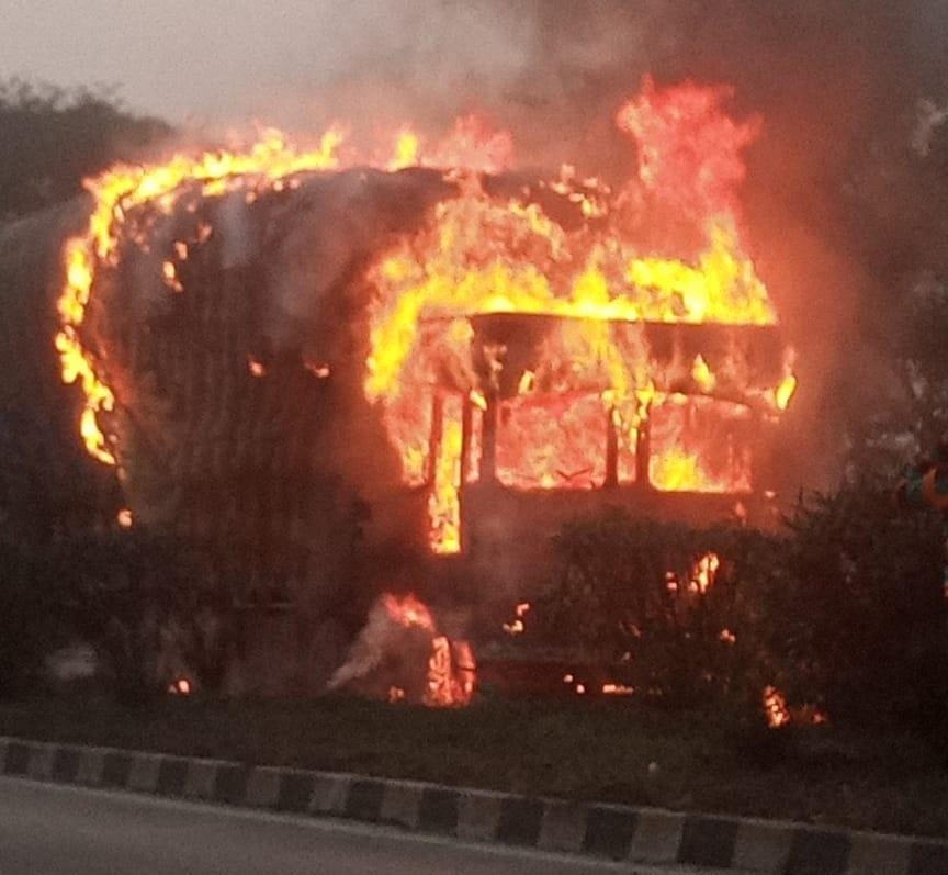 Truck burning in smoke on four lane