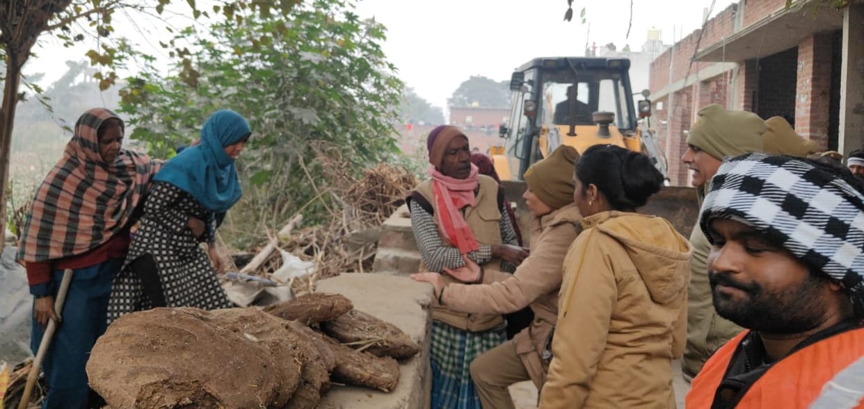 A woman climbed on a JCB in protest against the removal of illegal encroachment from the pond