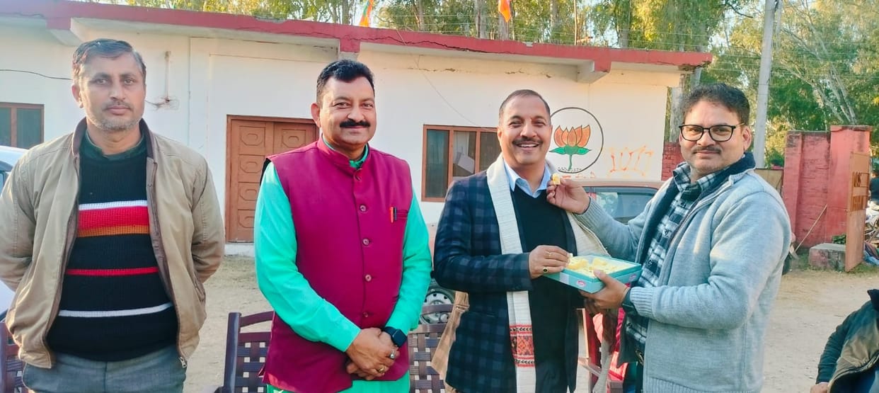 BJP District President congratulated the MLA on his birthday by feeding him sweets.