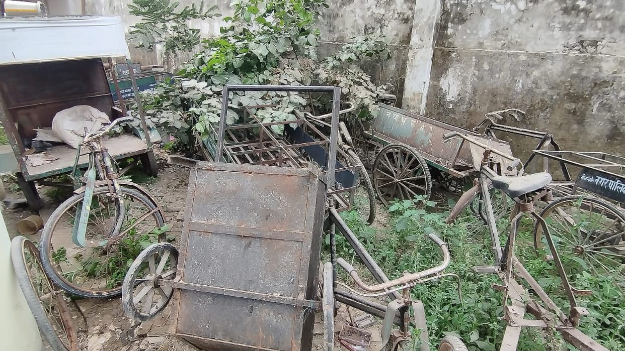 Door-to-door garbage collection system collapsed, vehicles rotting in the warehouse.