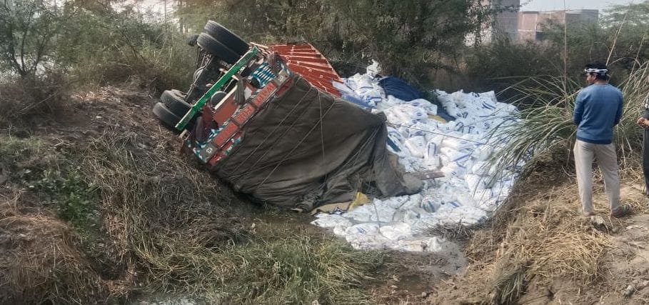 Truck overturns while trying to save bike rider, passenger trapped in cabin