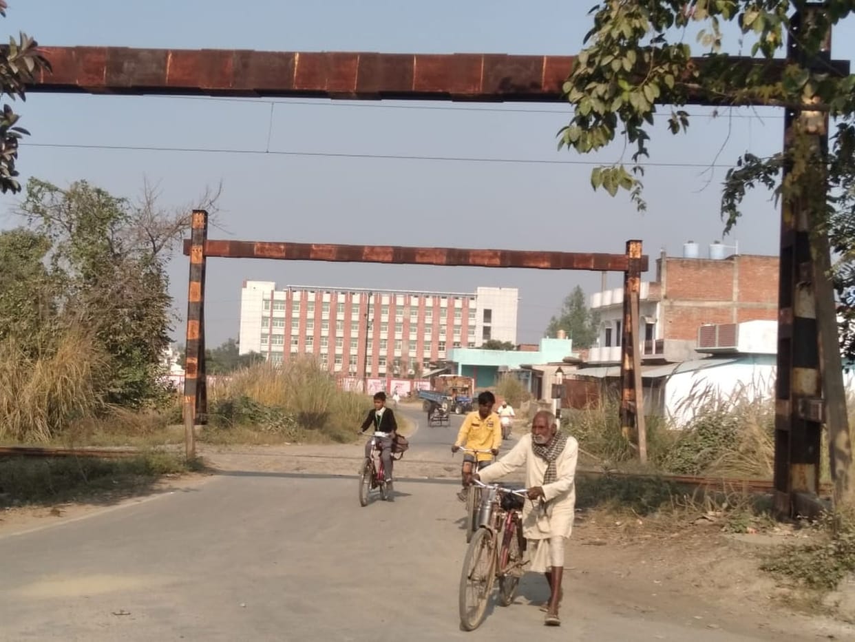 Crossing the railway crossing risking their lives