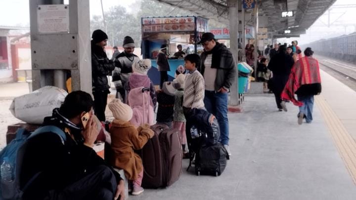 Passengers waiting for the train at Khalilabad railway station in the cold.