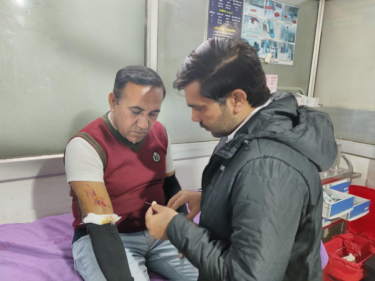 A pitbull dog bit a health centre employee badly, but officers let it go after he threw stones at them
