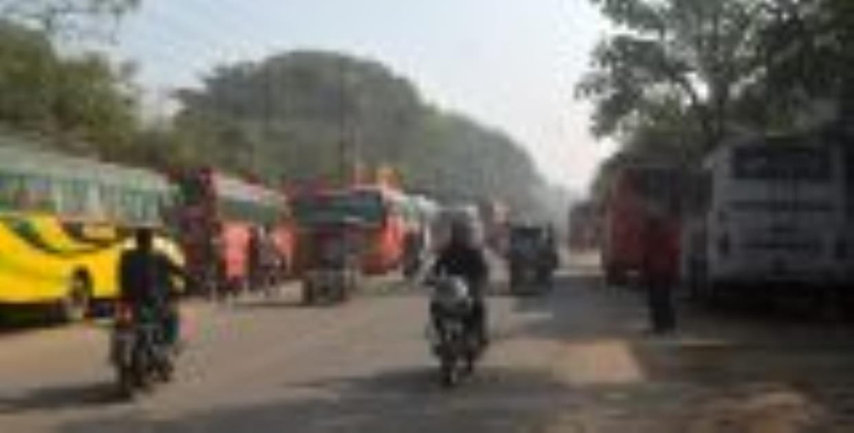 Private bus stands running on the footpath, causing jam on the road