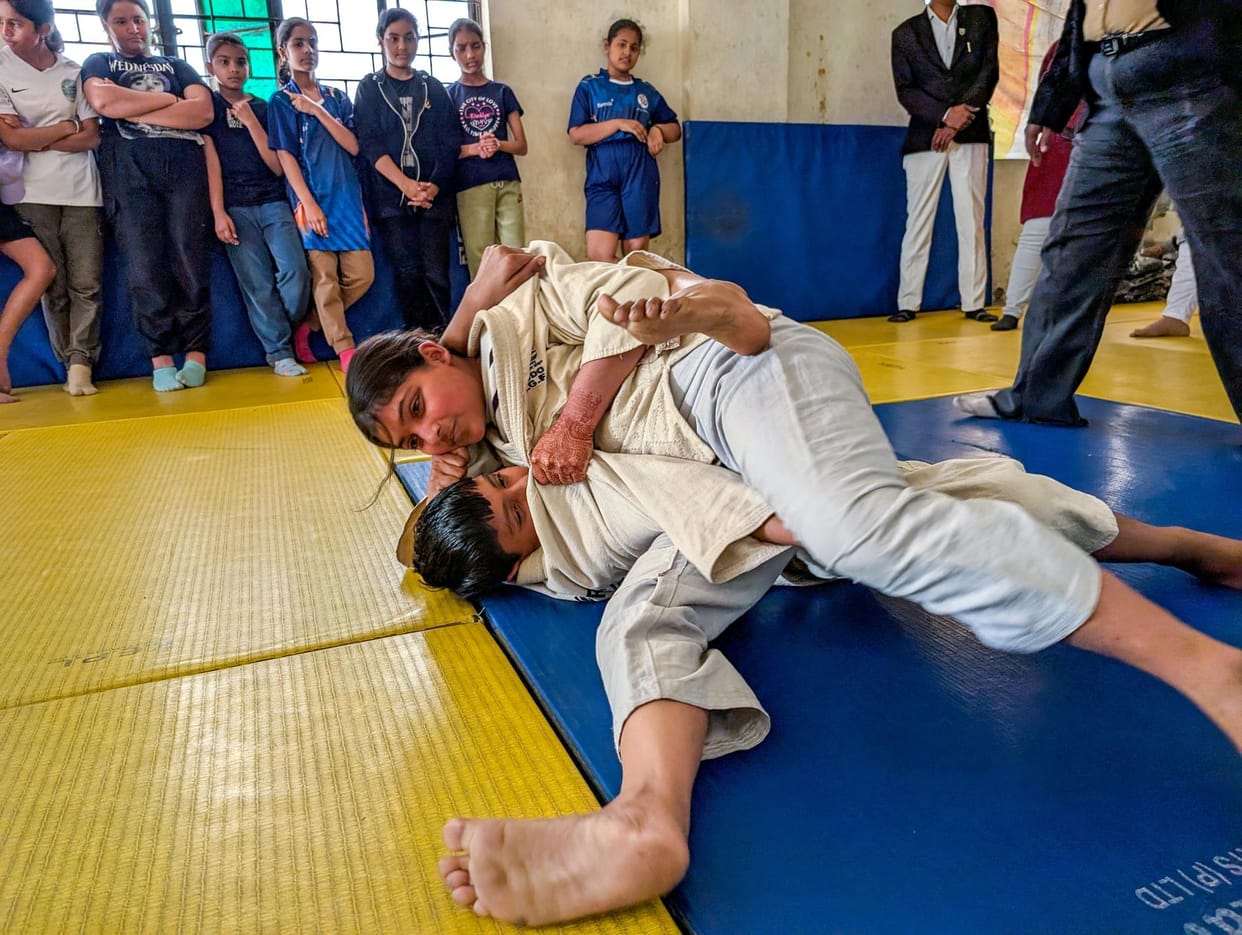 Players compete in judo competition at Mahamaya Stadium