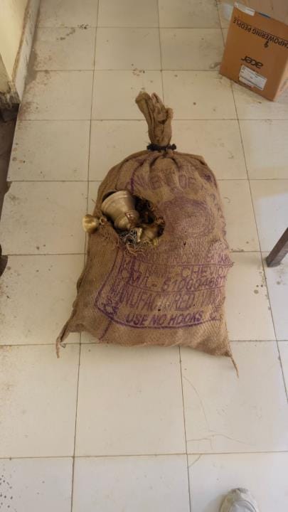 Sack full of brass bells found under millet curb