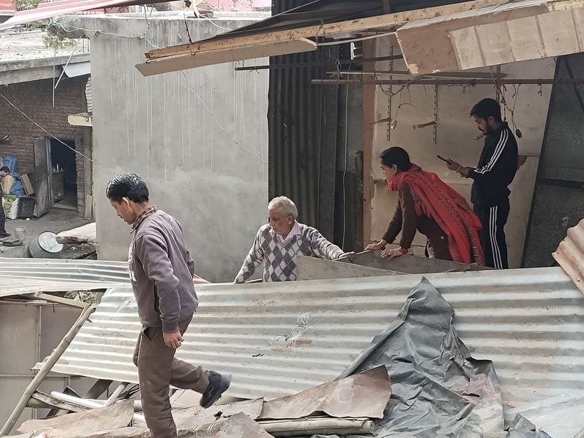 Shopkeepers were seen collecting goods from broken shops
