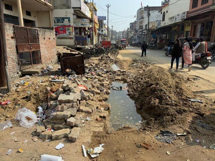 Road left dilapidated after laying pipe, difficult to even walk on foot