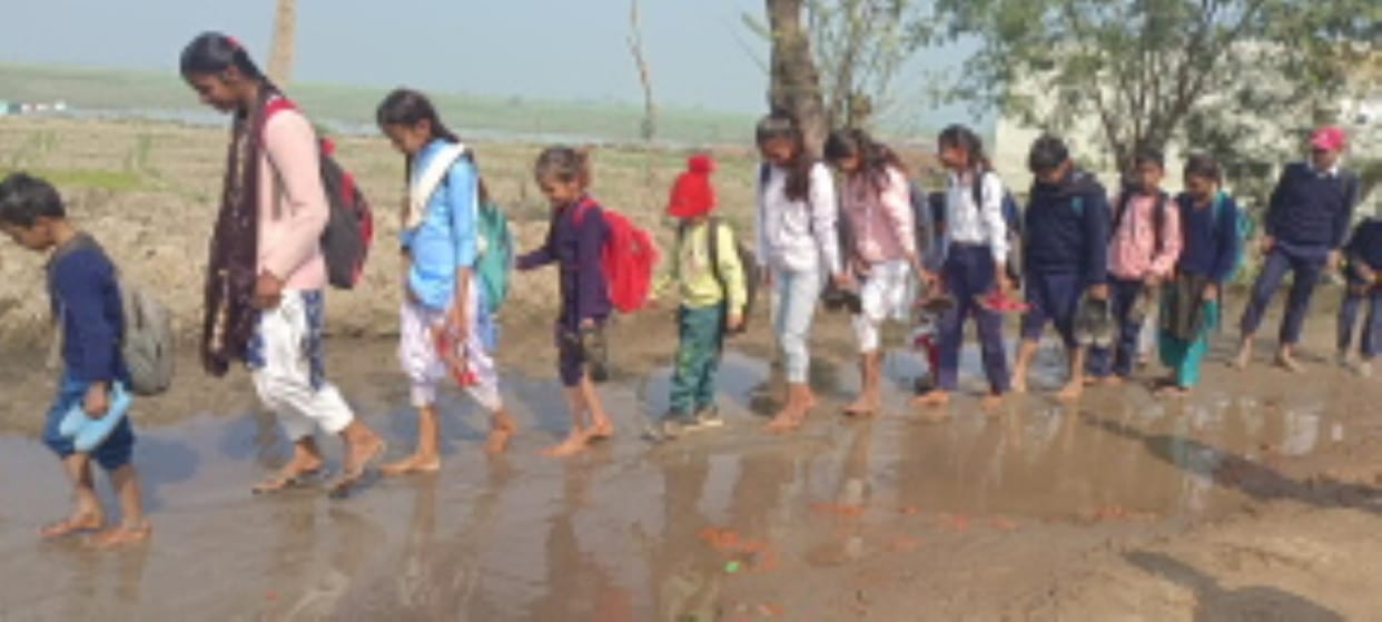 It is difficult to reach school, people have to cross the muddy road