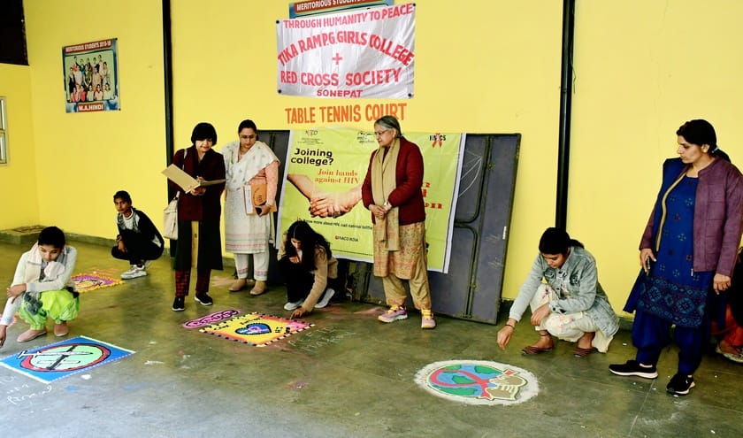 Students gave the message of protection from AIDS by making Rangoli