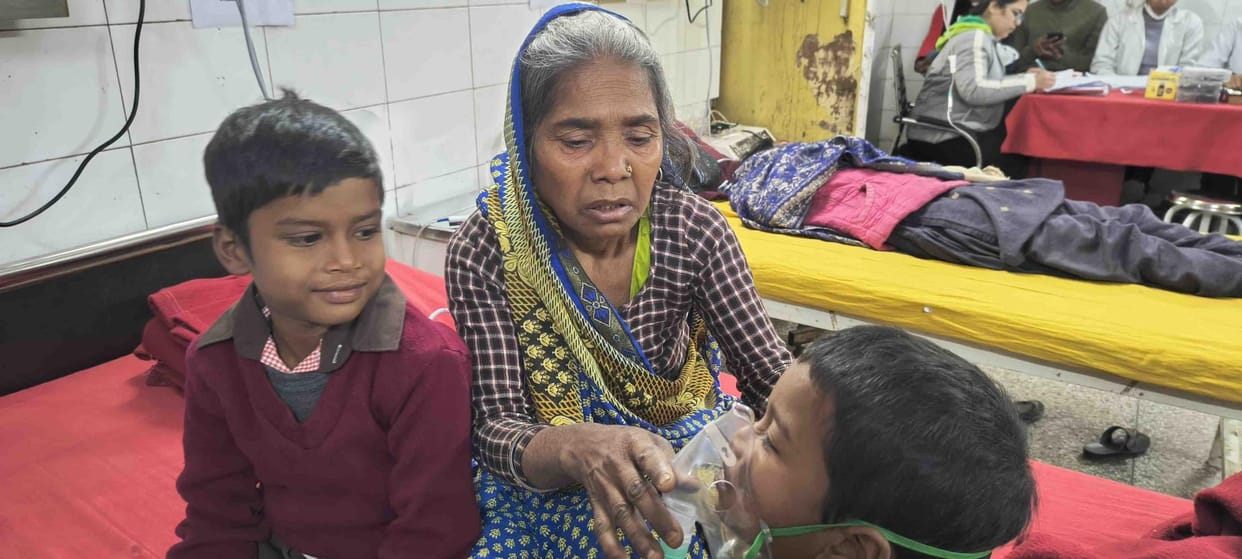 Old grandmother raising her grandchildren under a leaking roof