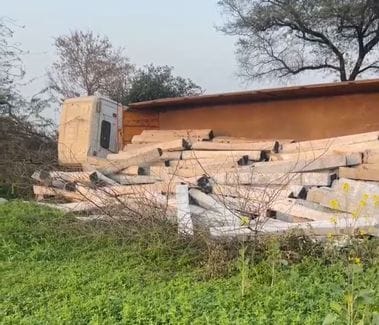 A trolley full of sleepers went out of control and overturned in the field.