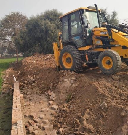 The contractor installed old bricks in the boundary wall of the cemetery, when he complained, he broke them with a JCB.