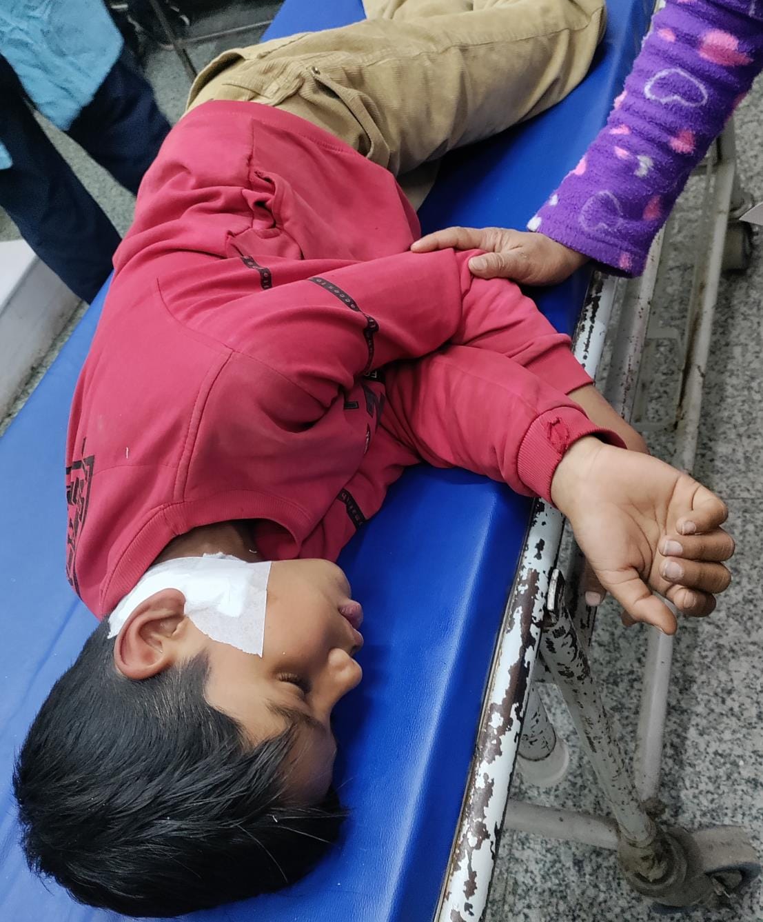 A young man standing outside his house was stabbed and injured