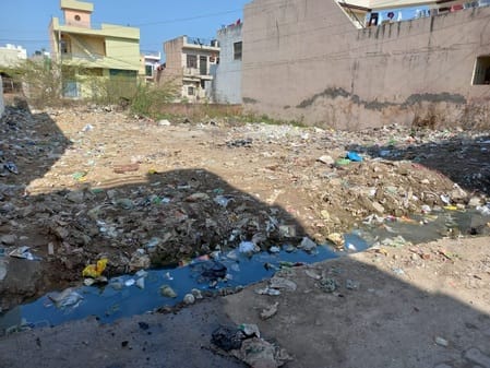 There is filth and broken drains in empty plots