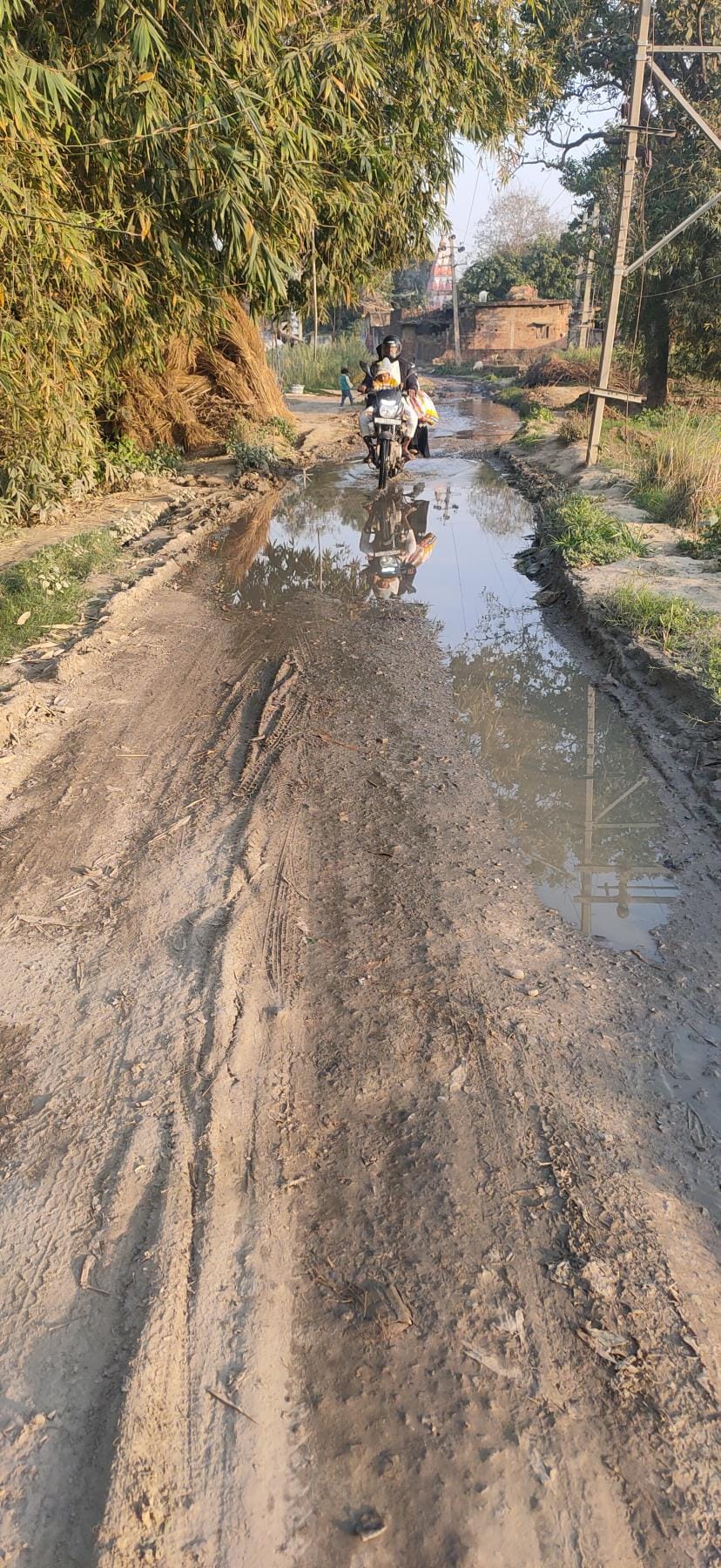 Road turned into drain, pedestrians passing through mud