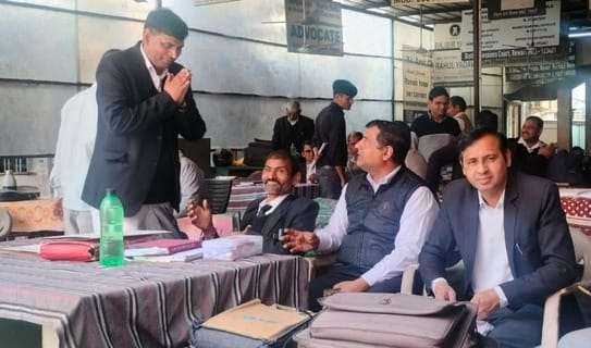Bar elections... someone is folding his hands and someone is asking for votes by falling at his feet.