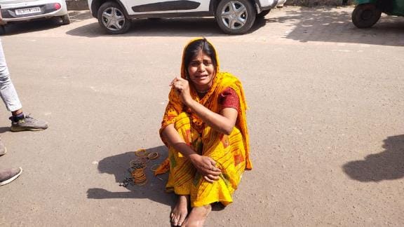 Upset over not getting the benefits of the scheme, the woman sat on the road