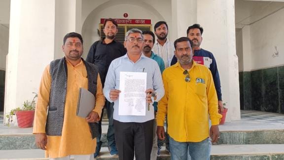 Accusation of occupying the land of Maa Shitala Dham temple