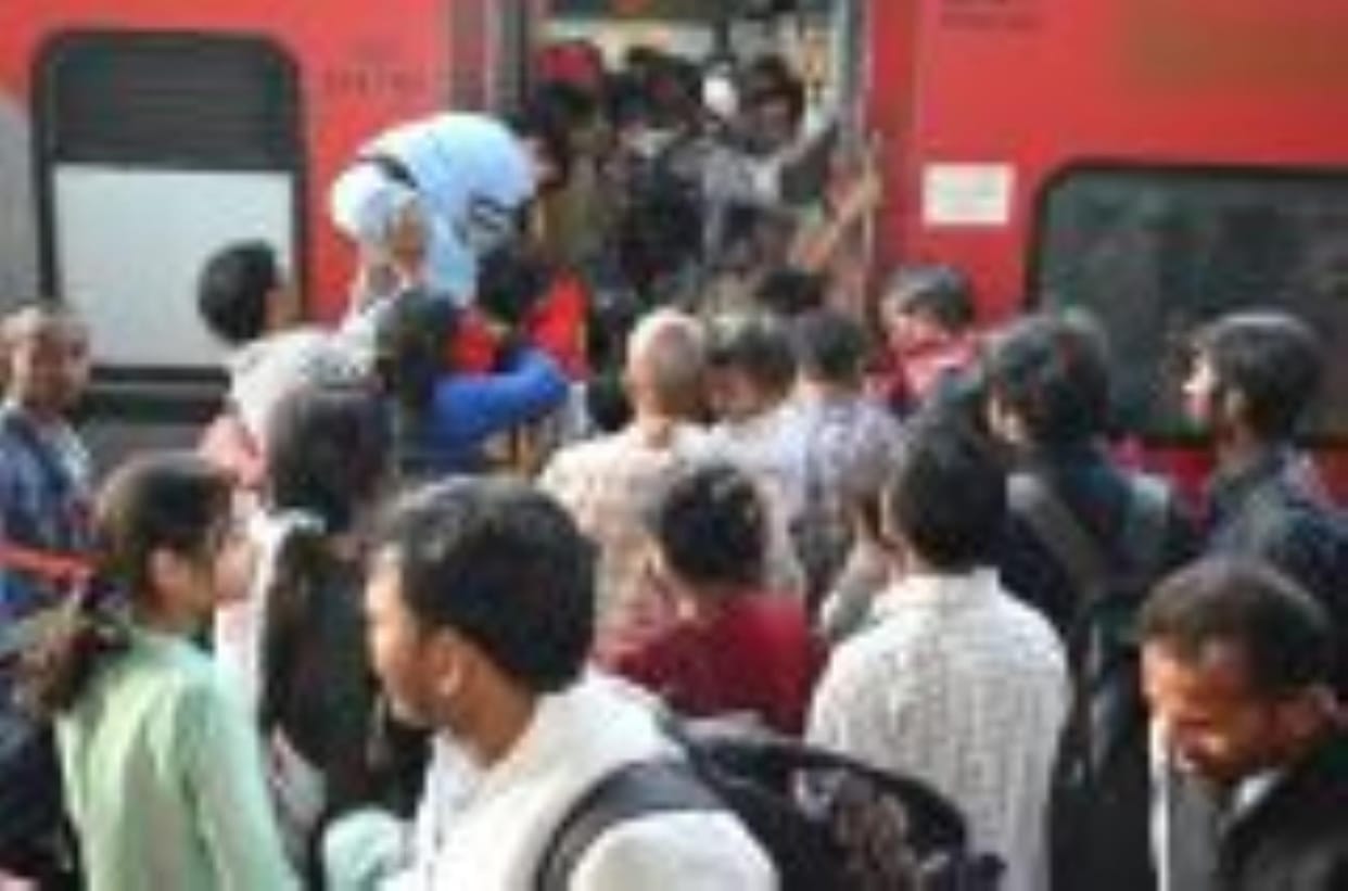 Devotees occupy every coach, doors closed, passengers enter train through window