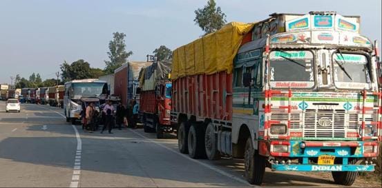 Heavy vehicles queued up along the four-lane highway