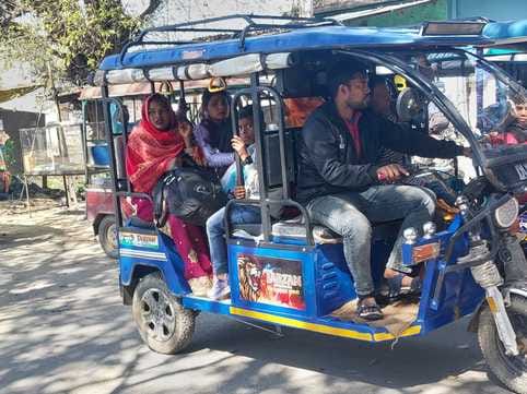 Passengers traveling by e-rickshaw on Barkheda-Gajraula road