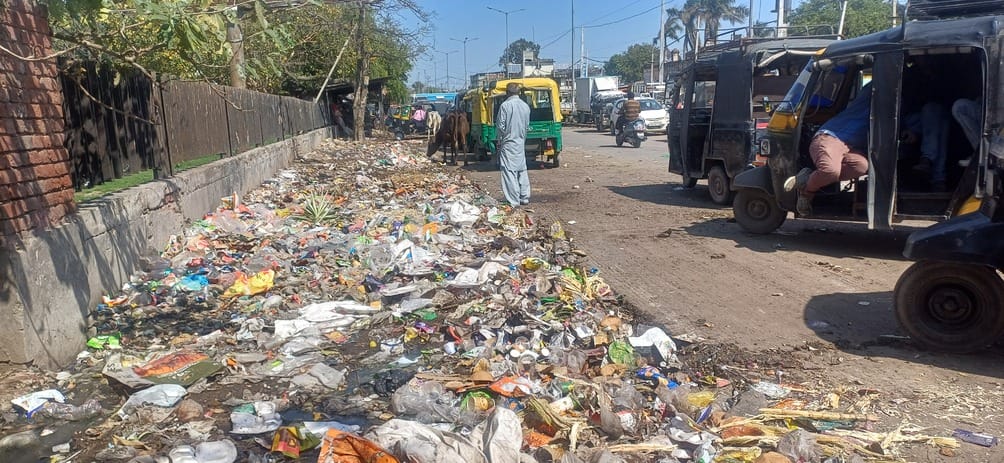 Pile of garbage outside the bus stand, drains overflowing