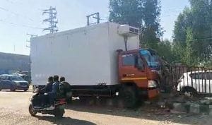 The truck climbed onto the divider after a car came in front