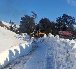 Truck-mounted snow blower machine gasping due to less snowfall, snow is being removed in Chanshal valley with the help of JCB
