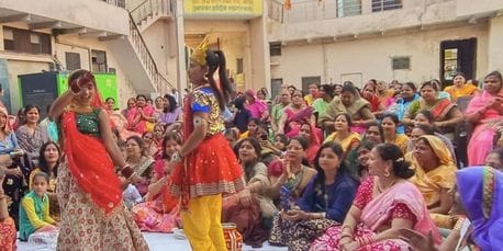 Women danced with the tableau of Radha-Krishna in Holi Milan