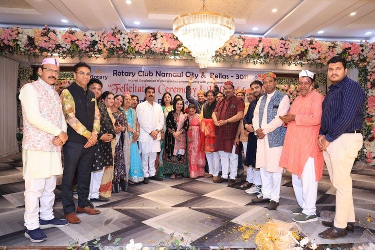 Rotary Club members played Holi by applying gulal on each other