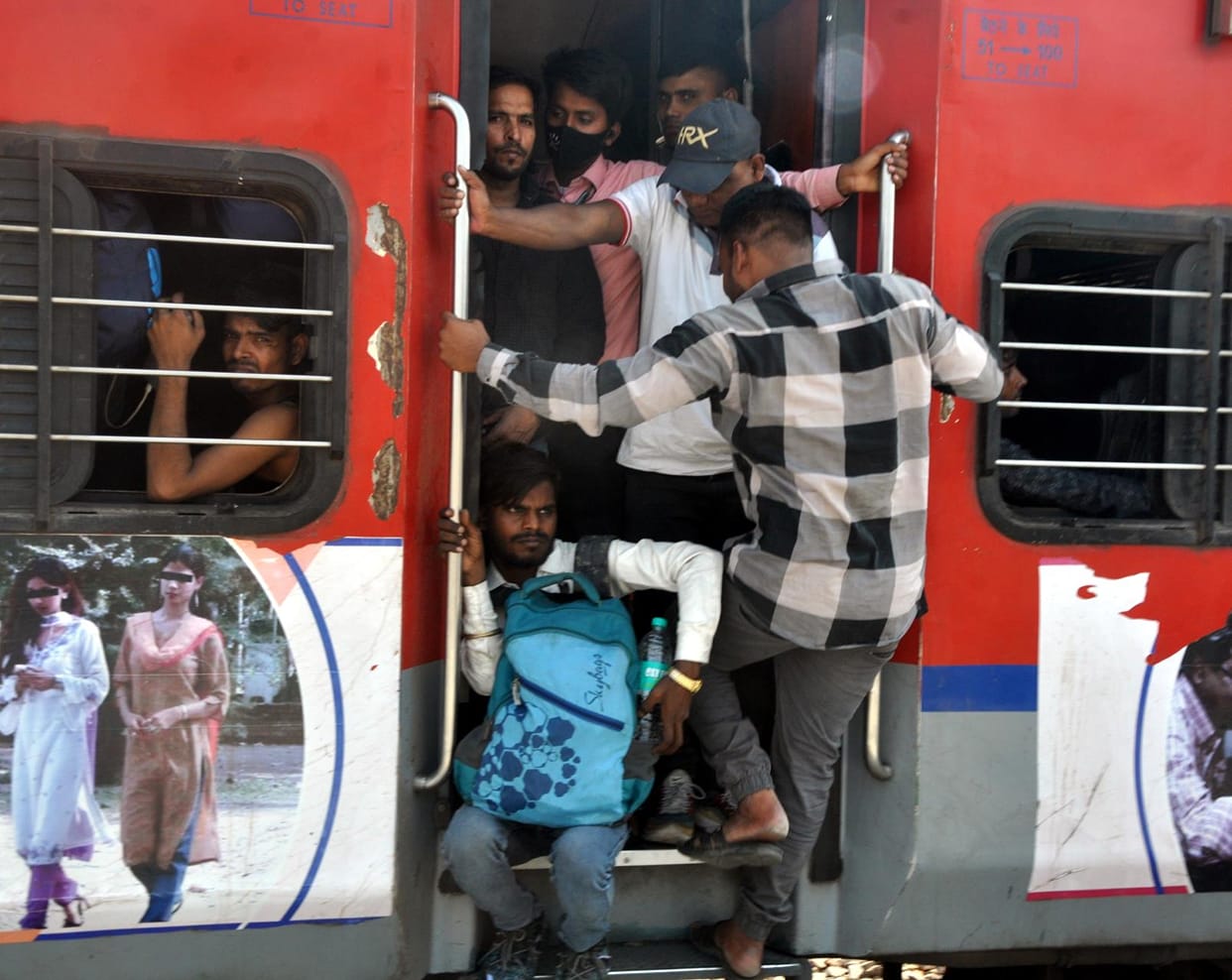 Risky journey... People reached home by hanging on trains and buses